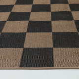 Covaba checkered easy jute indoor/outdoor rug in coffee brown, styled in a room setting, view 2