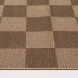 Covaba checkered easy jute indoor/outdoor rug in dune khaki, styled in a room setting, view 2