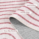 Covaba abstract rainbow stripe pink/white rug in blush clay, styled in a room setting, view 2