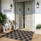 Covaba checkered easy jute indoor/outdoor area rug in coffee brown, styled in a room setting, view 3