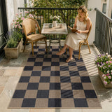 Covaba checkered easy jute indoor/outdoor area rug in coffee brown, styled in a room setting