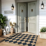Covaba geometric checkered easy jute indoor/outdoor area rug in ink black, styled in a room setting, view 14