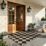 Covaba geometric checkered easy jute indoor/outdoor area rug in ink black, styled in a room setting, view 15