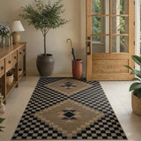 Covaba tribal soft easy jute indoor/outdoor area rug in ink black, styled in a room setting