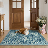 Covaba vintage woodcut forest and rabbit area rug in stormy blue, styled in a room setting, view 6