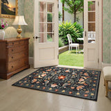 Covaba boho birdsong floral garden area rug in ink black, styled in a room setting, view 11