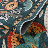 Covaba egyptian-inspired botanical rug in teal haze, styled in a room setting, view 2
