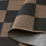 Covaba checkered easy jute indoor/outdoor rug in coffee brown, styled in a room setting