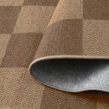 Covaba checkered easy jute indoor/outdoor rug in dune khaki, styled in a room setting