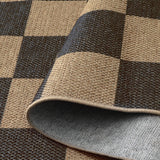 Covaba checkered easy jute natural indoor/outdoor rug in ink black, styled in a room setting, view 2