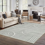 Covaba abstract rainbow stripe black/beige area rug in warm beige, styled in a room setting, view 3