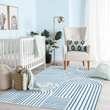 Covaba abstract rainbow stripe blue/white area rug in stormy blue, styled in a room setting, view 8