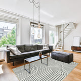 Covaba abstract rainbow stripe black/beige area rug in warm beige, styled in a room setting