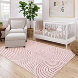 Covaba abstract rainbow stripe pink/white area rug in blush clay, styled in a room setting, view 6