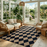 Covaba geometric checkered easy jute indoor/outdoor area rug in coffee brown, styled in a room setting, view 8