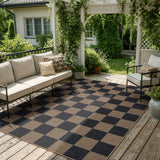 Covaba checkered easy jute indoor/outdoor area rug in coffee brown, styled in a room setting, view 6