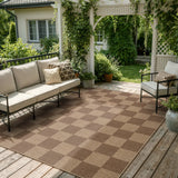 Covaba checkered easy jute indoor/outdoor area rug in dune khaki, styled in a room setting