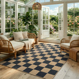 Covaba checkered easy jute natural indoor/outdoor area rug in ink black, styled in a room setting, view 9