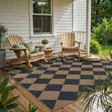 Covaba geometric checkered easy jute indoor/outdoor area rug in stormy blue, styled in a room setting, view 8