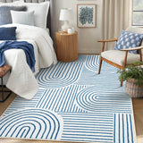 Covaba abstract rainbow stripe blue/white area rug in stormy blue, styled in a room setting, view 2