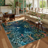 Covaba jungle midnight area rug in stormy blue, styled in a room setting, view 2