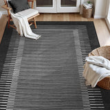 Covaba modern minimalist line area rug in ink black, styled in a room setting, view 5
