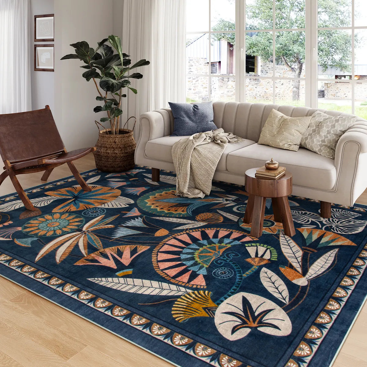 Covaba egyptian-inspired botanical area rug in deep navy, styled in a room setting