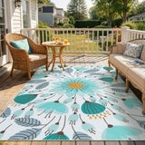 Covaba floral indoor outdoor area rug in stormy blue, styled in a room setting
