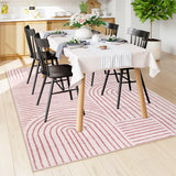 Covaba abstract rainbow stripe pink/white area rug in blush clay, styled in a room setting, view 3