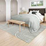 Covaba abstract rainbow stripe black/beige area rug in warm beige, styled in a room setting, view 7