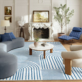 Covaba abstract rainbow stripe blue/white area rug in stormy blue, styled in a room setting, view 5