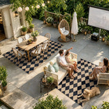 Covaba geometric checkered easy jute indoor/outdoor area rug in coffee brown, styled in a room setting, view 7