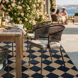 Covaba geometric checkered easy jute indoor/outdoor area rug in coffee brown, styled in a room setting, view 3