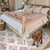 Covaba meadow floral area rug in blush clay, styled in a room setting, view 3