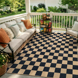 Covaba checkered easy jute natural indoor/outdoor area rug in ink black, styled in a room setting, view 2