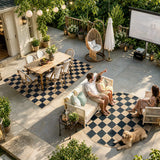 Covaba checkered easy jute natural indoor/outdoor area rug in ink black, styled in a room setting