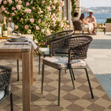Covaba geometric checkered easy jute indoor/outdoor area rug in dune khaki, styled in a room setting, view 4