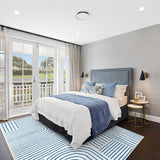 Covaba abstract rainbow stripe blue/white area rug in stormy blue, styled in a room setting, view 4