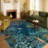 Covaba jungle midnight area rug in stormy blue, styled in a room setting, view 5