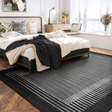 Covaba modern minimalist line area rug in ink black, styled in a room setting, view 3
