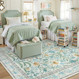 Covaba boho modern parisian garden floral area rug in stormy blue, styled in a room setting