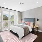 Covaba abstract rainbow stripe pink/white area rug in blush clay, styled in a room setting, view 4