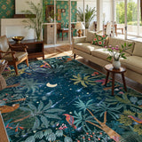 Covaba jungle midnight area rug in stormy blue, styled in a room setting, view 10