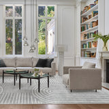 Covaba abstract rainbow stripe black/beige area rug in warm beige, styled in a room setting, view 2