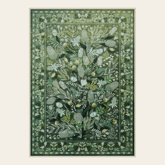 Covaba modern botanical floral area rug in fern green, shown flat on a plain ivory backdrop