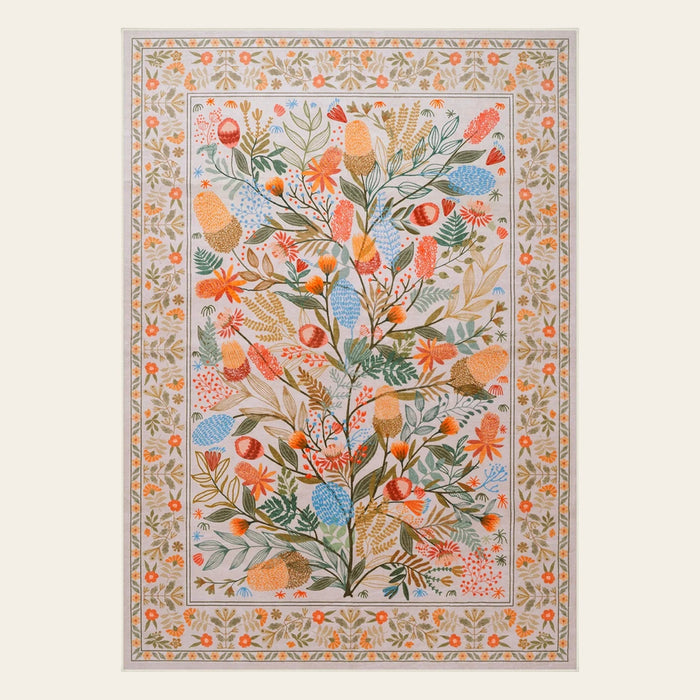 Covaba modern natural botanical floral area rug in multicolor, shown flat on a plain ivory backdrop