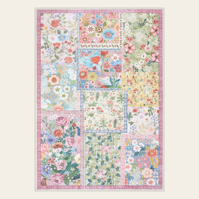 Covaba patchwork cottagecore floral area rug in blush clay, shown flat on a plain ivory backdrop