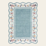 Covaba vintage floral scalloped doormat in dusty blue, shown flat on a plain ivory backdrop
