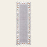 Covaba vintage floral scalloped runner rug in muted plum, shown flat on a plain ivory backdrop