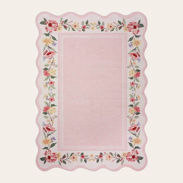 Covaba vintage floral scalloped area rug in blush clay, shown flat on a plain ivory backdrop